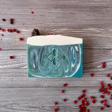 Load image into Gallery viewer, Handcrafted Christmas soap bar with emerald green marbled swirls and a snowy white top. Vegan artisan holiday soap with engraved pattern, festive handmade gift for Christmas and winter skincare.