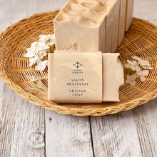 Load image into Gallery viewer, The soap bar is labeled and wrapped with recyclable paper for an eco-friendly touch. The label features the company logo and the words Artisan Soap in both French and English.