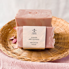 Load image into Gallery viewer, The soap bar is labeled and wrapped with recyclable paper for an eco-friendly touch. The label features the company logo and the words Artisan Soap in both French and English.