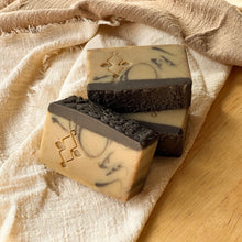Load image into Gallery viewer, Natural handmade coffee soap bars with dark textured tops and marbled tan bases, featuring an embossed Woods and Mosses logo on the side.