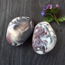 Load image into Gallery viewer, A soap bar shaped like a rock with white, brown, and dark violet swirls.