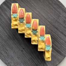 Load image into Gallery viewer, The soap top is deep yellow, textured, with a small orange-green carrot decoration. Carrot Soap - Woods and Mosses