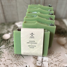 Load image into Gallery viewer, The soap bar is labeled and wrapped with recyclable paper for an eco-friendly touch. The label features the company logo and the words Artisan Soap in both French and English.