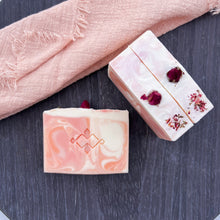 Load image into Gallery viewer, Handcrafted soap bar in peachy rose and ivory tones with a stamped  Woods and Mosses design and dried rosebud embedded in the side, ideal for sensitive or dry skin.