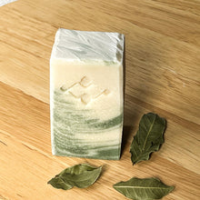 Load image into Gallery viewer, Bay Leaf & Chlorophyll Soap Bar. Front view of natural green artisan soap with swirl design and dried bay leaves.
