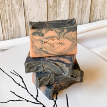 Load image into Gallery viewer, Elegant artisan soap featuring dramatic swirls of black and peach, perfect for a luxurious skincare routine.