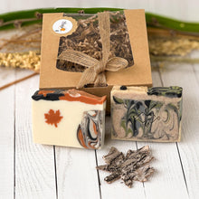 Load image into Gallery viewer, Handcrafted soap bars with autumn-inspired swirls and a maple leaf motif, styled with rustic packaging and natural decor.