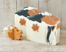 Load image into Gallery viewer, Square soap bar with a wavy top. Design: beige soap with an orange maple leaf and some black-orange waves. The top is orange and black with orange maple leaves and some glitter.