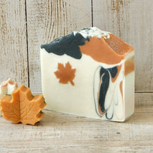 Load image into Gallery viewer, Square soap bar with a wavy top. Design: beige soap with an orange maple leaf and some black-orange waves. The top is orange and black with orange maple leaves and some glitter.