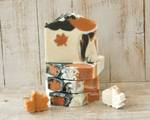 Load image into Gallery viewer, Square soap bar with a wavy top. Design: beige soap with an orange maple leaf and some black-orange waves. The top is orange and black with orange maple leaves and some glitter.