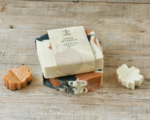 Load image into Gallery viewer, The soap bar is labeled and wrapped with recyclable paper. On the label: companyβs logo and two signs Artisan Soap in French and English.