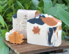 Load image into Gallery viewer, Square soap bar with a wavy top. Design: beige soap with an orange maple leaf and some black-orange waves. The top is orange and black with orange maple leaves and some glitter.