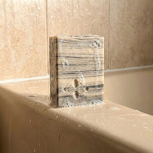 Load image into Gallery viewer, Birch Design soap bar with soap suds, gray and ivory birchwood stripes, clean beveled edges and embossed logo.