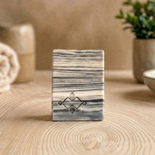 Load image into Gallery viewer, A square soap bar with a birch bark pattern in white, gray, and black, featuring a stamped logo in the corner. Ideal for gifting or as a decorative bathroom accent.