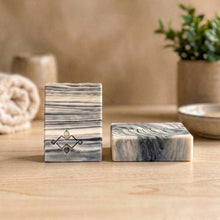 Load image into Gallery viewer, A square soap bar with a birch bark pattern in white, gray, and black, featuring a stamped logo in the corner. Ideal for gifting or as a decorative bathroom accent.