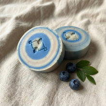 Charger l'image dans la galerie, Two round soaps with blue layered rings, one showing the stamped design and one displaying the thick side profile.