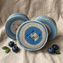Charger l'image dans la galerie, Round artisan soap bars with blue and cream rings, showing Woods and Mosses geometric stamp and natural swirl pattern.