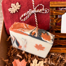 Load image into Gallery viewer, Beige soap bar featuring an orange maple leaf design, accented with black-orange waves, topped with orange and black hues, adorned with orange maple leaves and a hint of glitter.