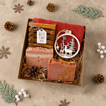 Load image into Gallery viewer, Open men’s Christmas gift box with two handmade soaps, wooden soap dish, red cotton face cloth, ornament, and gift tag.