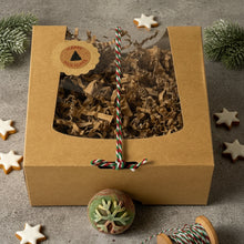 Load image into Gallery viewer, Closed kraft box with festive snowflake soap and holiday wrapping cord.
