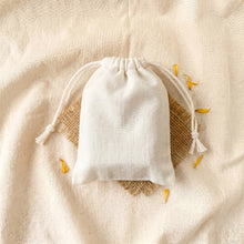 Load image into Gallery viewer, Calendula turmeric organic soap presented inside a plain white drawstring bag
