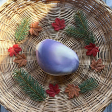 Charger l'image dans la galerie, The artisan soap bar is designed to look like a rock, with a smooth white surface and vibrant purple swirls resembling natural stone patterns.