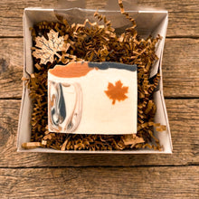 Load image into Gallery viewer, Maple leaf handmade soap bar with cream, orange, and charcoal swirls in a kraft gift box