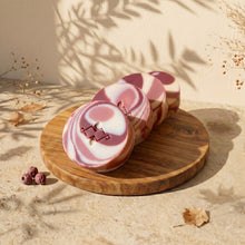 Load image into Gallery viewer, Four round Cranberry Yogurt soap bars lined up to show swirls, stamp, and thickness
