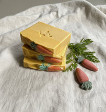 Load image into Gallery viewer, Stacked handcrafted shea butter soap bars with raised carrot design