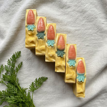 Load image into Gallery viewer, Six handmade carrot soap bars arranged diagonally with raised carrot embeds