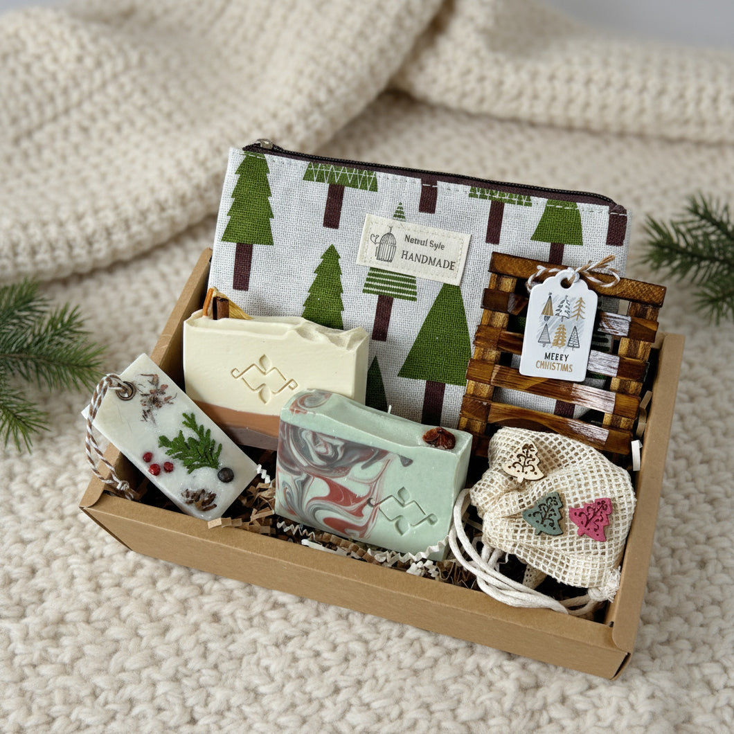 Christmas spa gift box for women with handmade natural soaps, wooden soap dish, festive pouch, and eco accessories arranged in a kraft box on a knitted blanket.