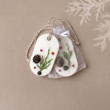 Charger l'image dans la galerie, Two white botanical soy wax sachets with hanging cords, one partly inside a sheer organza bag