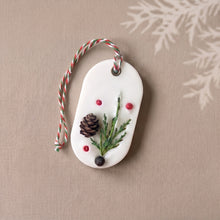Charger l'image dans la galerie, White soy wax sachet with red and green hanging cord, evergreen sprig, mini pinecone, and berry accents