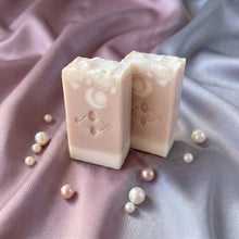 Load image into Gallery viewer, Two collagen shea butter soap bars standing upright, one angled in front and one behind.