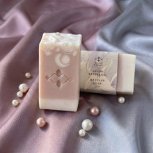 Load image into Gallery viewer, Pink and cream collagen soap bar with embossed logo beside wrapped bar in Woods and Mosses paper sleeve.