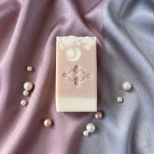 Load image into Gallery viewer, Single artisan collagen soap bar shown flat with pale pink center, white base, and embossed front.