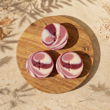 Load image into Gallery viewer, Three round artisan soap bars with pink, cream, and burgundy cranberry-style swirls