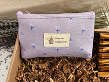 Load image into Gallery viewer, Luxury Lavender Spa Gift Basket, Christmas Edition by Woods and Mosses: Pale purple, pillow-shaped makeup bag adorned with a floral print and equipped with a zipper.