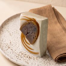 Load image into Gallery viewer, Fall Vibes handmade soap bar with cream base, ochre swirls, and raised brown tree with heart cutouts.