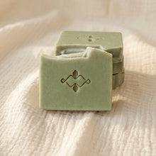 Load image into Gallery viewer, Two pale green frankincense and orange soap bars on beige fabric