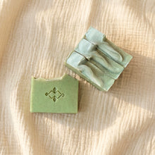 Load image into Gallery viewer, Pale green frankincense and orange soap bars arranged on beige fabric