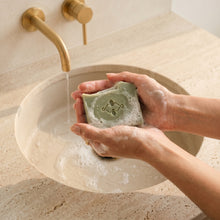 Load image into Gallery viewer, Hands washing with pale green frankincense and orange soap at a sink