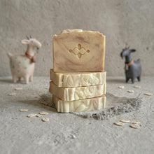 Charger l'image dans la galerie, Stack of four handmade goat milk and oatmeal soap bars, showing swirled tops and cut sides.