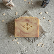 Charger l'image dans la galerie, Top view of a handmade goat milk and oatmeal soap bar with soft pink and cream marbling.