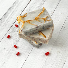 Load image into Gallery viewer, Three rectangular artisan soaps with a frosted white base and embedded natural speckles, decorated with golden branch-like accents on the surface, creating an elegant festive design.