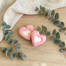 Load image into Gallery viewer, Two pink heart-shaped mini soaps with white centers, handmade guest bars for travel or powder room use