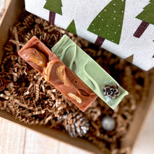 Load image into Gallery viewer, Holiday Self-Care Gift Box featuring the soap tops adorned with organic decor.