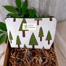 Load image into Gallery viewer, Holiday Self-Care Gift Box featuring canvas cosmetic bag adorned with green fir tree prints.