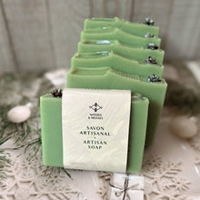 Load image into Gallery viewer, The soap bar is labeled and wrapped with recyclable paper for an eco-friendly touch. The label features the company logo and the words Artisan Soap in both French and English.