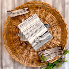 Load image into Gallery viewer, A square soap bar with a birch bark pattern in white, gray, and black, featuring a stamped Woods and Mosses logo in the corner. Ideal for gifting or as a decorative bathroom accent.